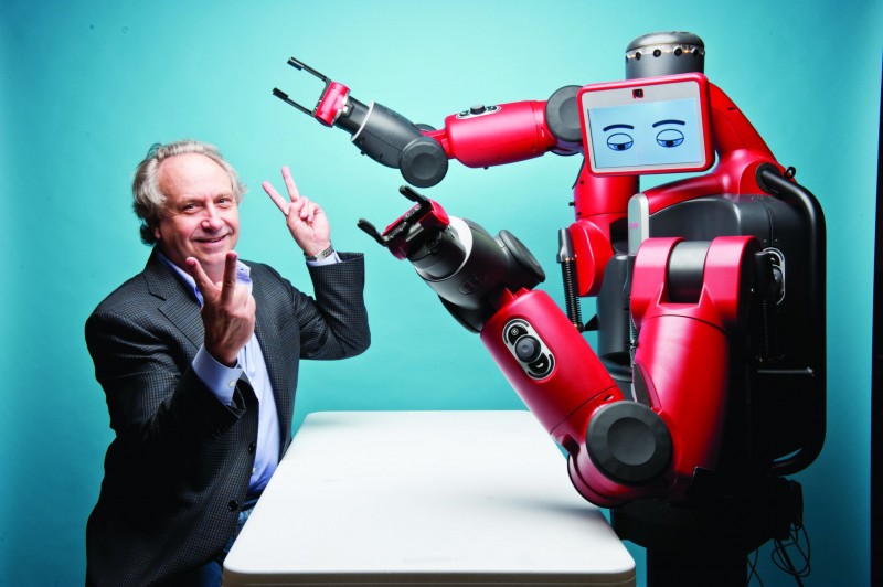 The magazine's cover star, Rodney Brooks, plays up to the camera with his humanoid robot Baxter.